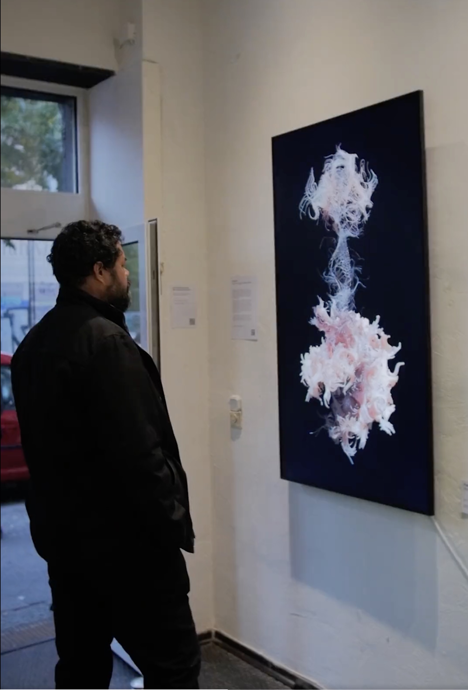 A gallery visitor viewing the work